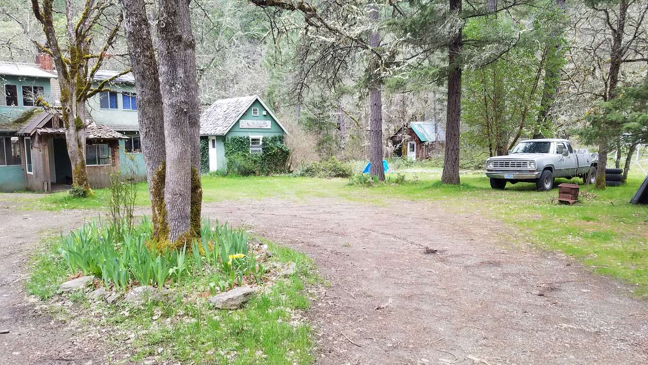 Main parking area with house, Ivy Guesthouse, and Cabin the background. Oak camping is on the knoll by the dome to the far right. 