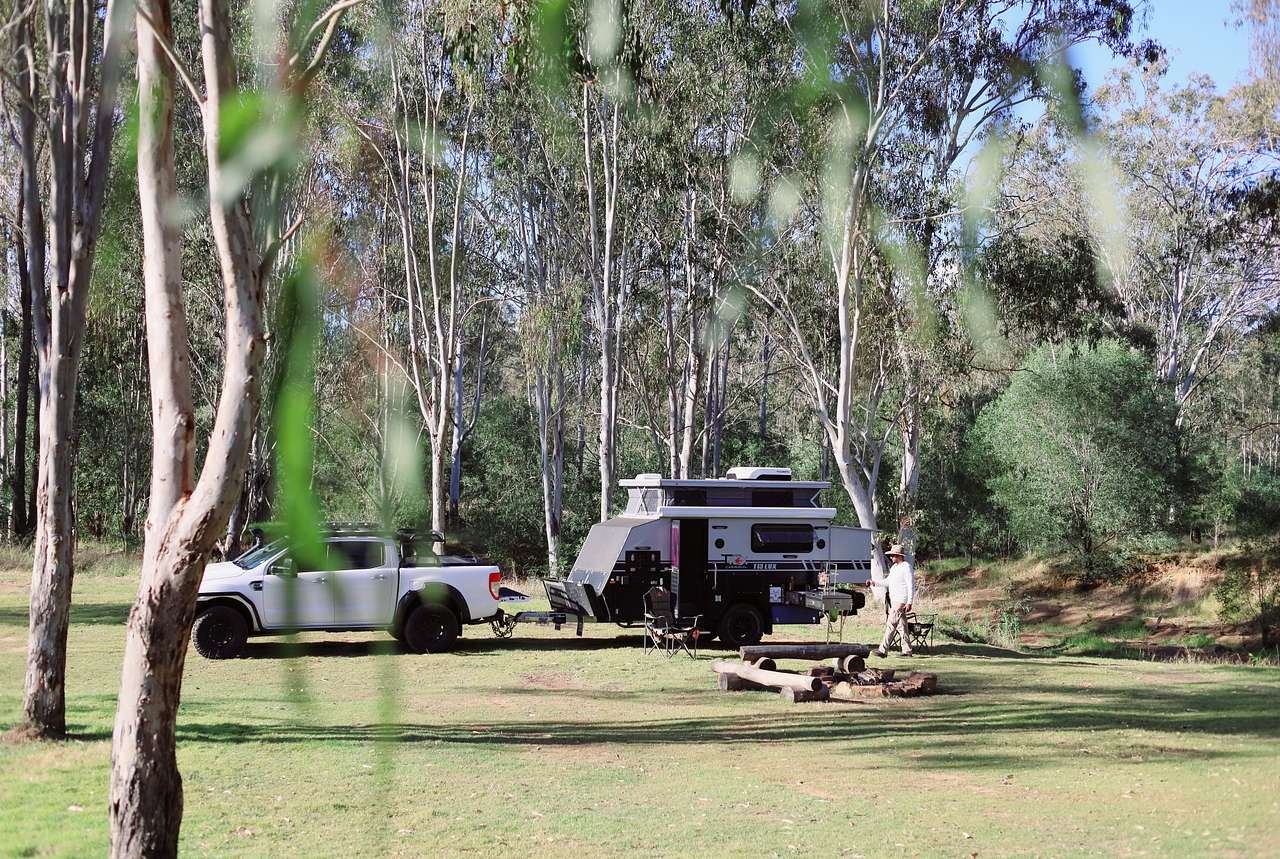 The campsite has a flat, grassy ground perfect for all types of camping setups. 