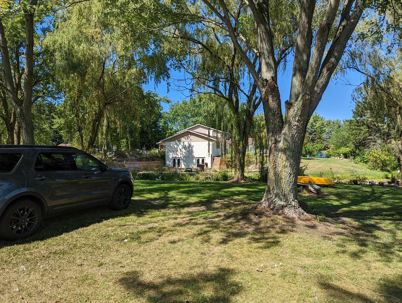 A campsite area with the host's home in the background