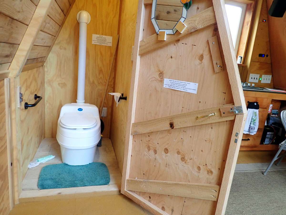 Swedish Composting toilet, it separates water and solid waste. Sit down for men and women.  Theres a fan that needs to be on when you are staying in the aframe. The switch is under the far cabinet.