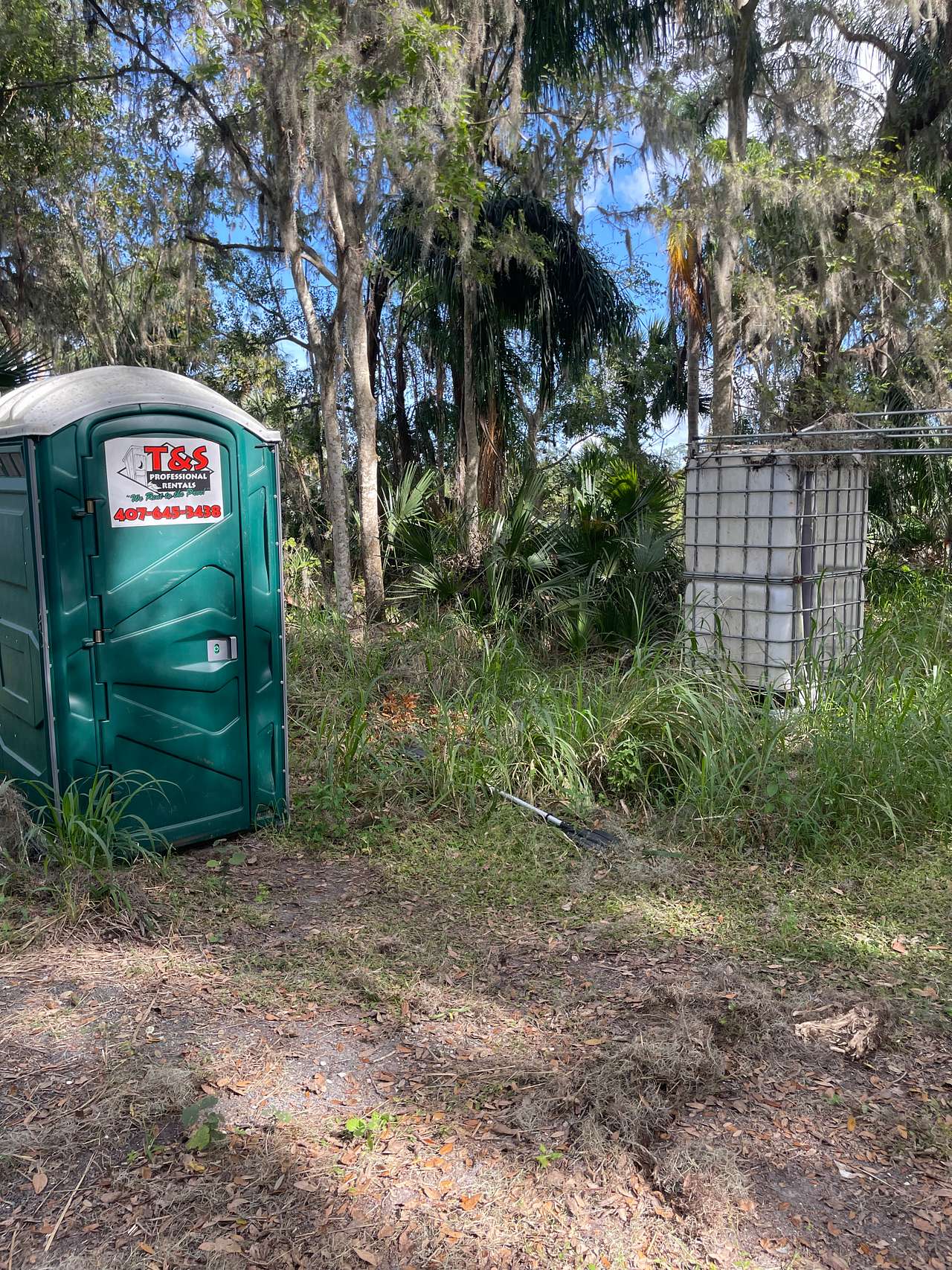 Portapotty with old shower next to it