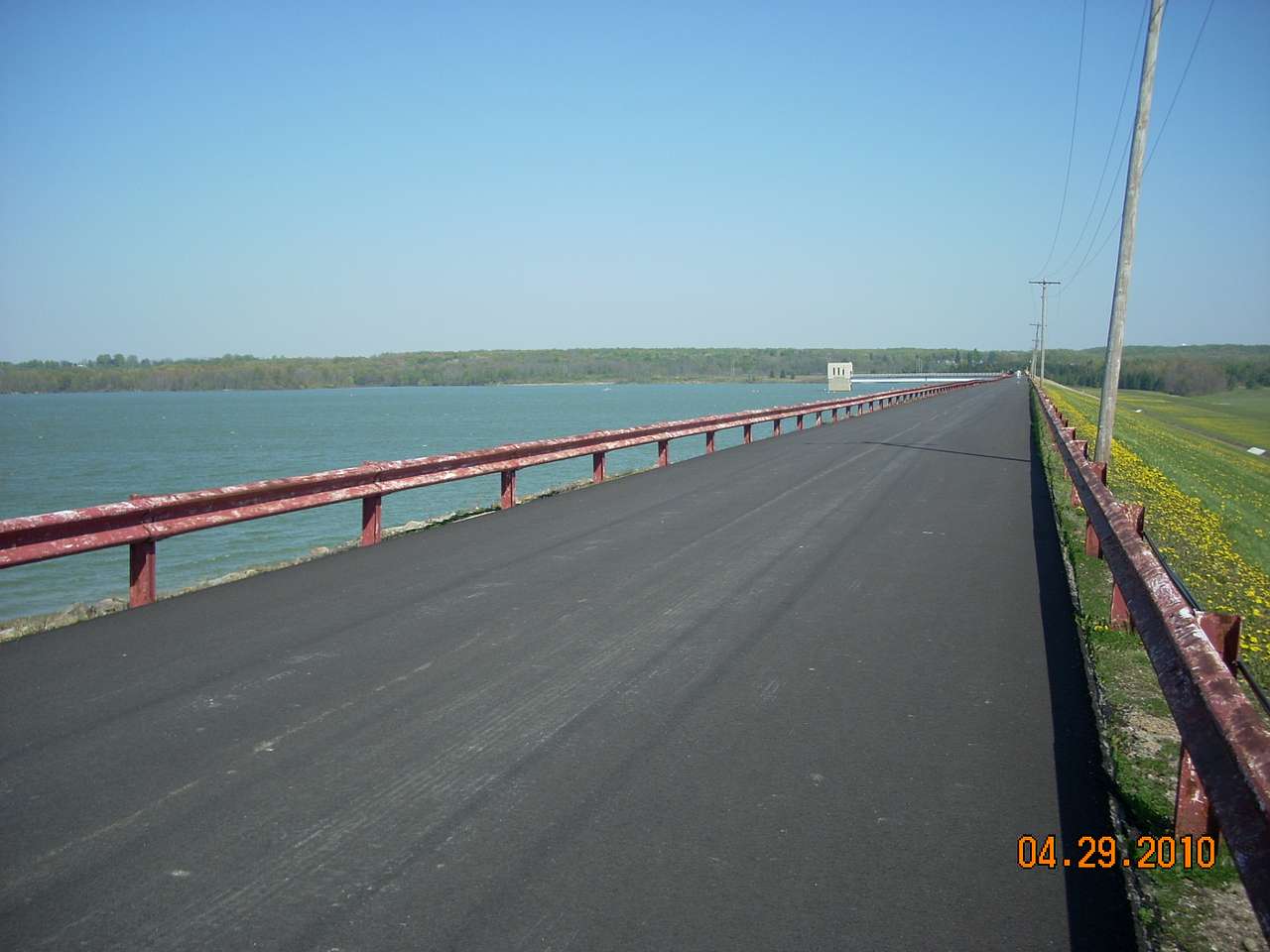 the view of the lake and reservoir from the top of the rolled-earth dam