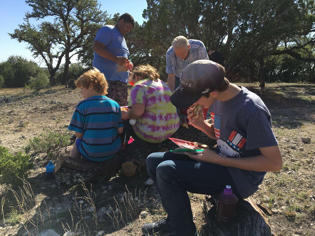 Grandkids eating sandwiches  on West Side/Cliff Side Of Lake! 