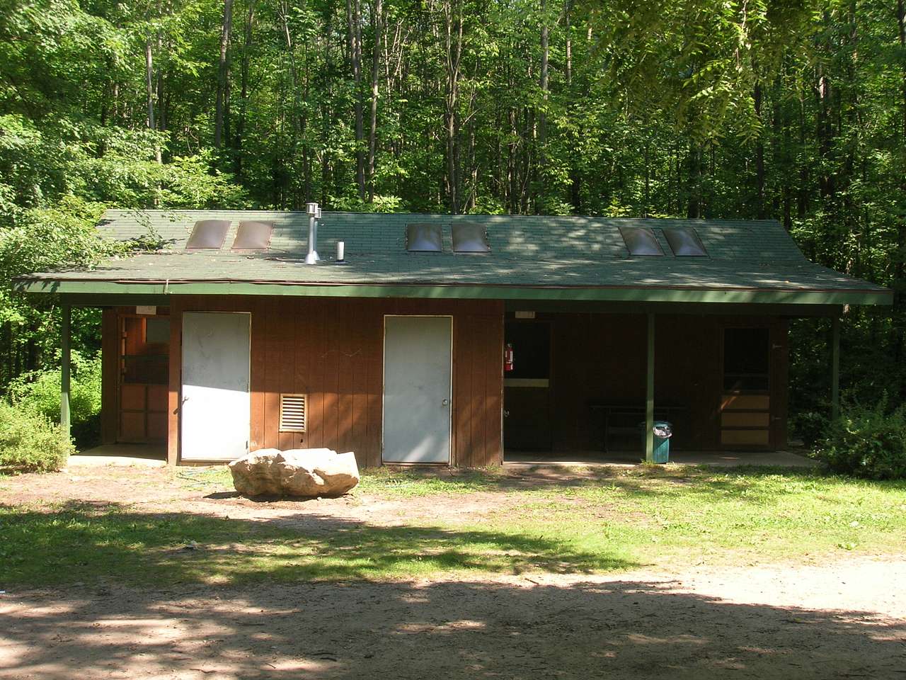 Shower House divided into 3 sections. Each section has two toilets, two sinks and two showers with hot and cold water. 