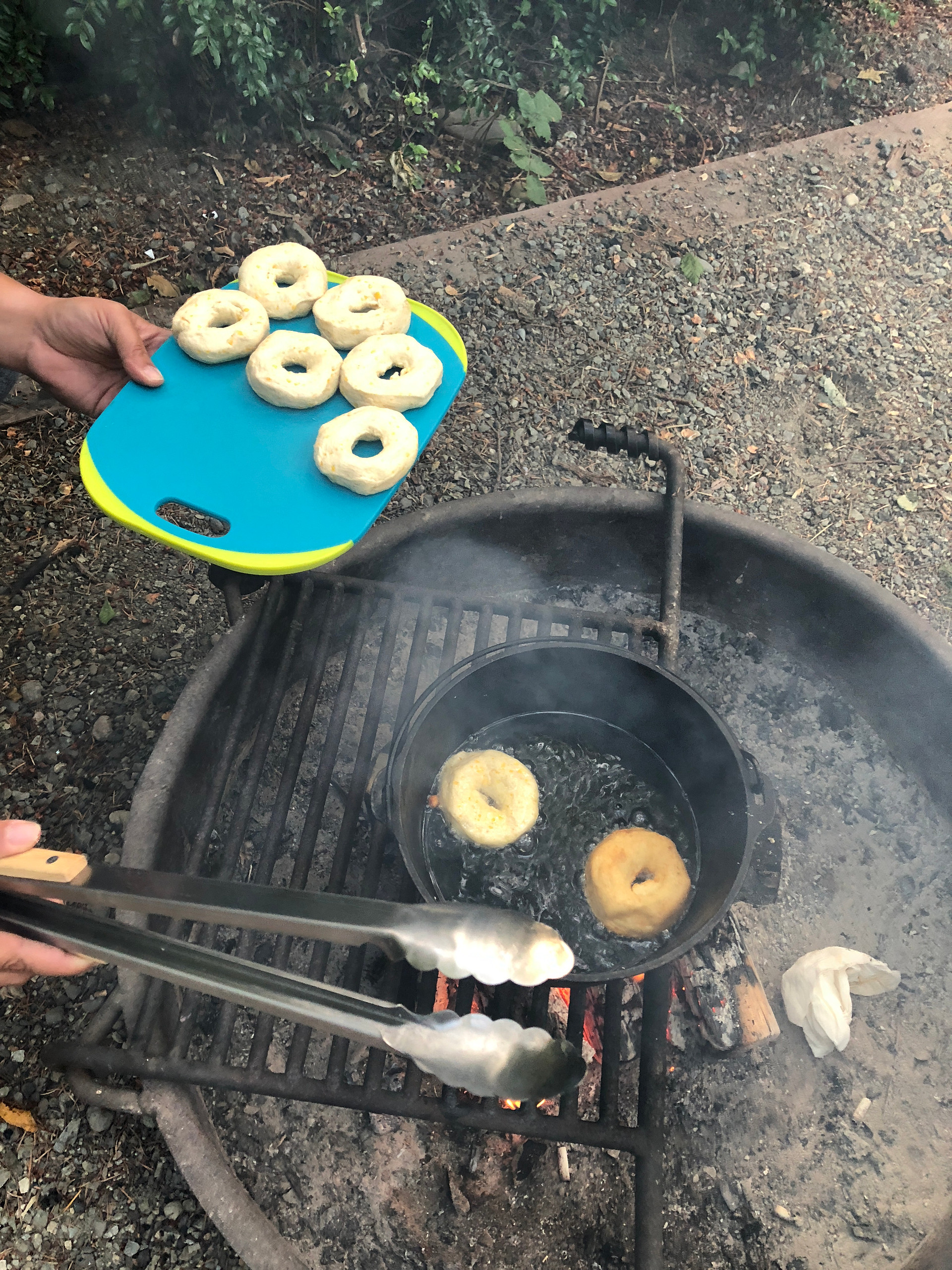 Each fire pit has a grate on a hinge that makes for easy cooking over the flames. When not needed it just flips over outside of the ring.