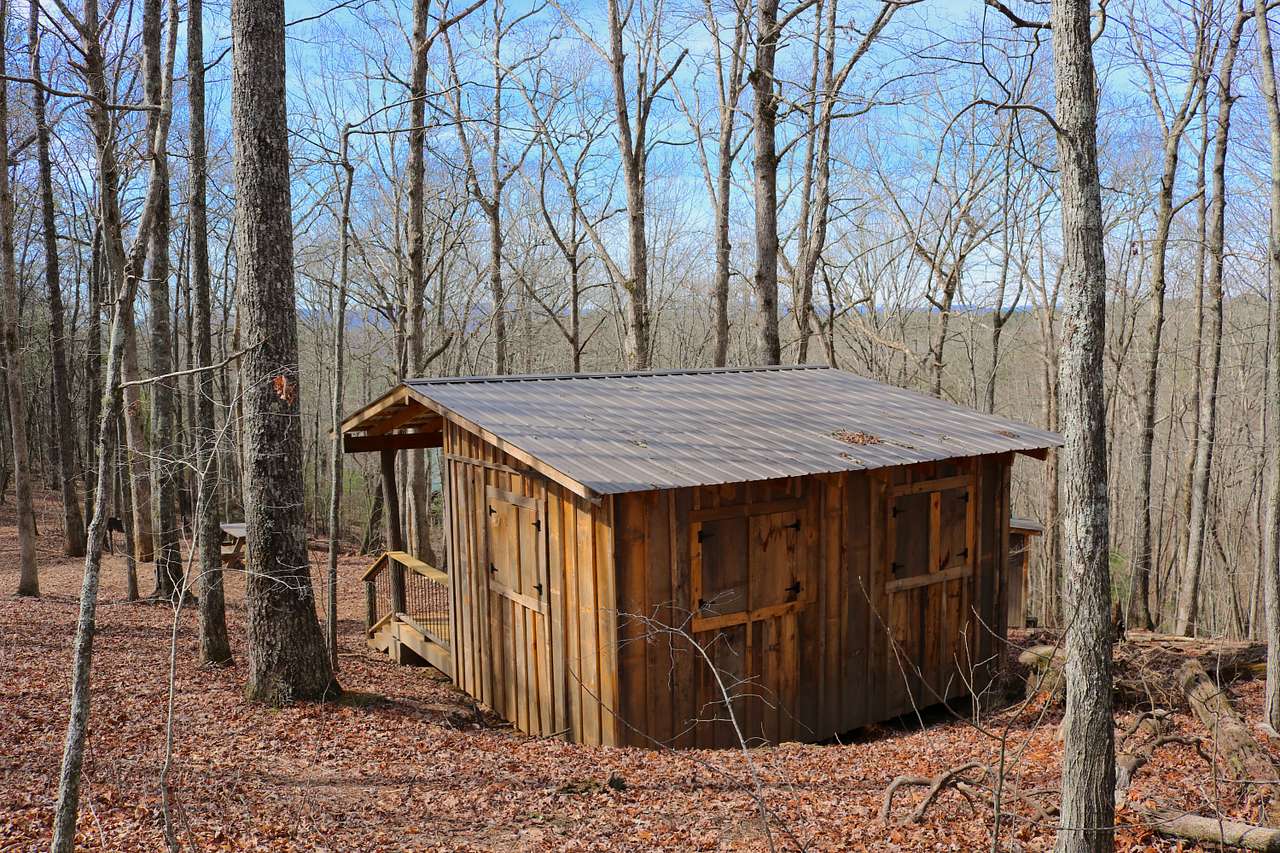 the Mountaintop shelter is nestled in the hillside and has four big windows with storm shutters