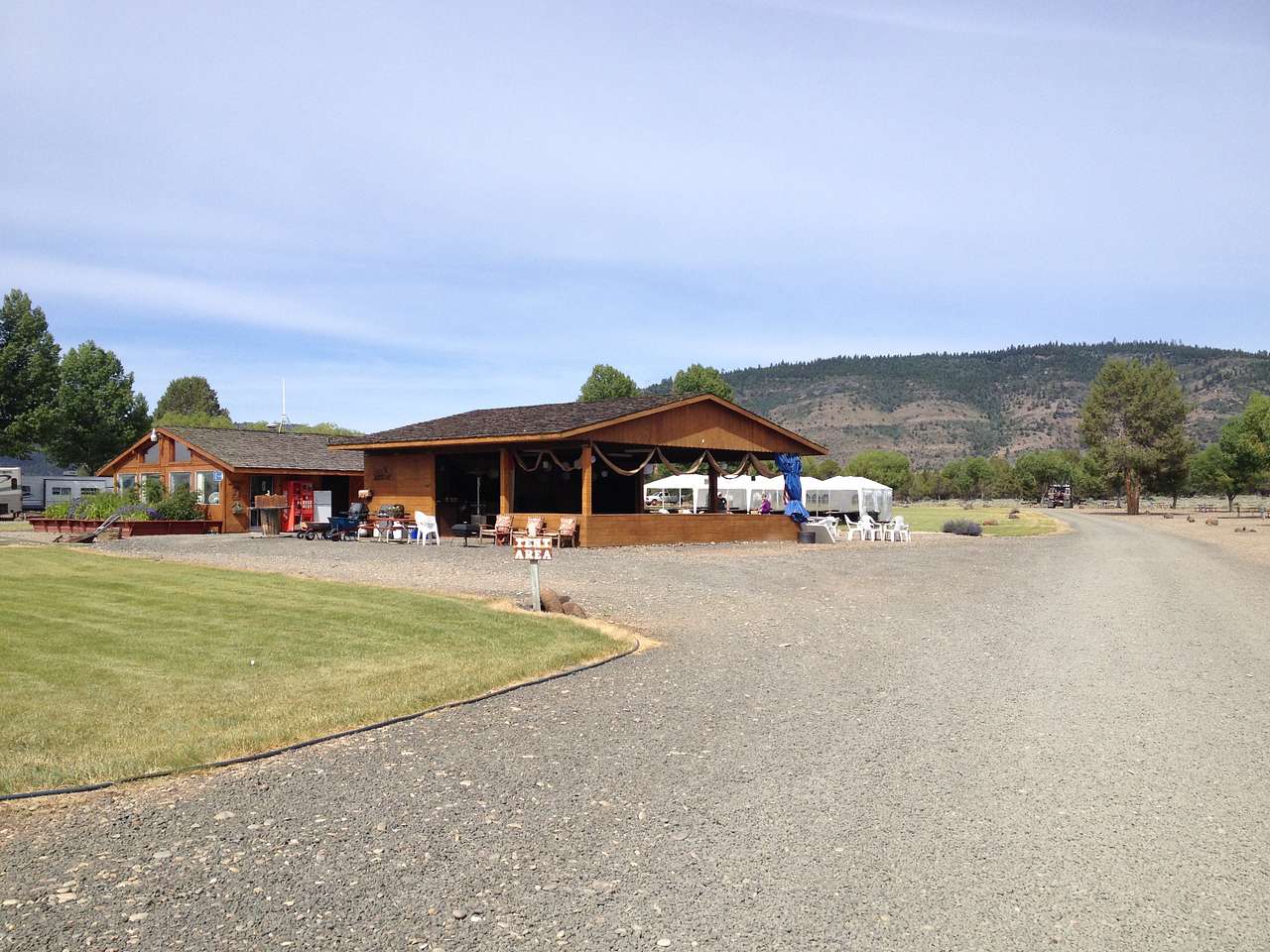 Open air pavilion with tables and chairs to eat and mingle.