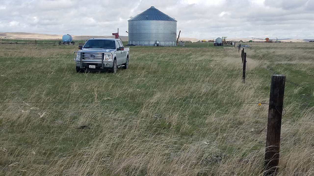 Area where pickup is parked is parking area for a rv