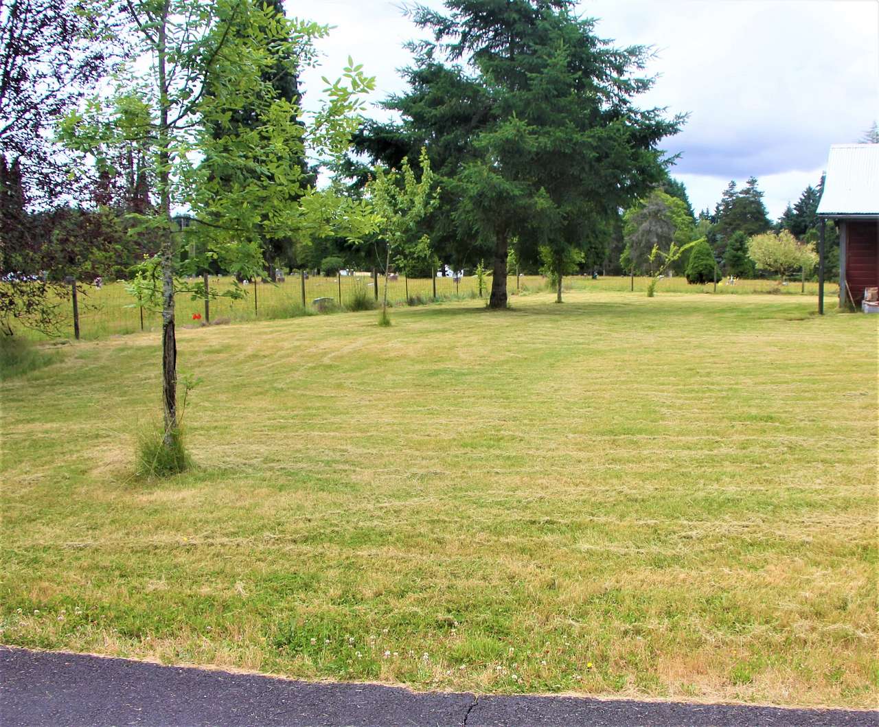 Side of the barn, showing cemetery behind