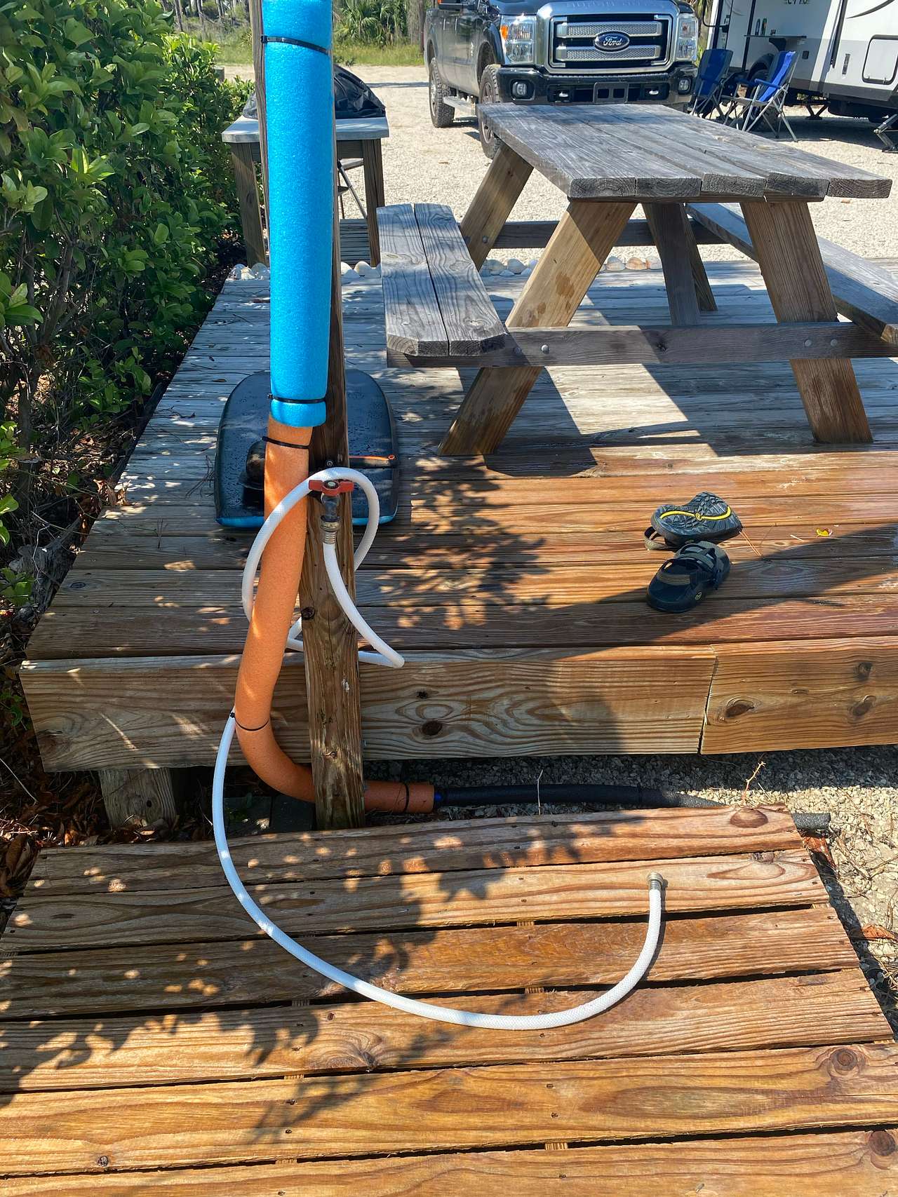 Outdoor shower plus hose for washing off sand and beach gear.
