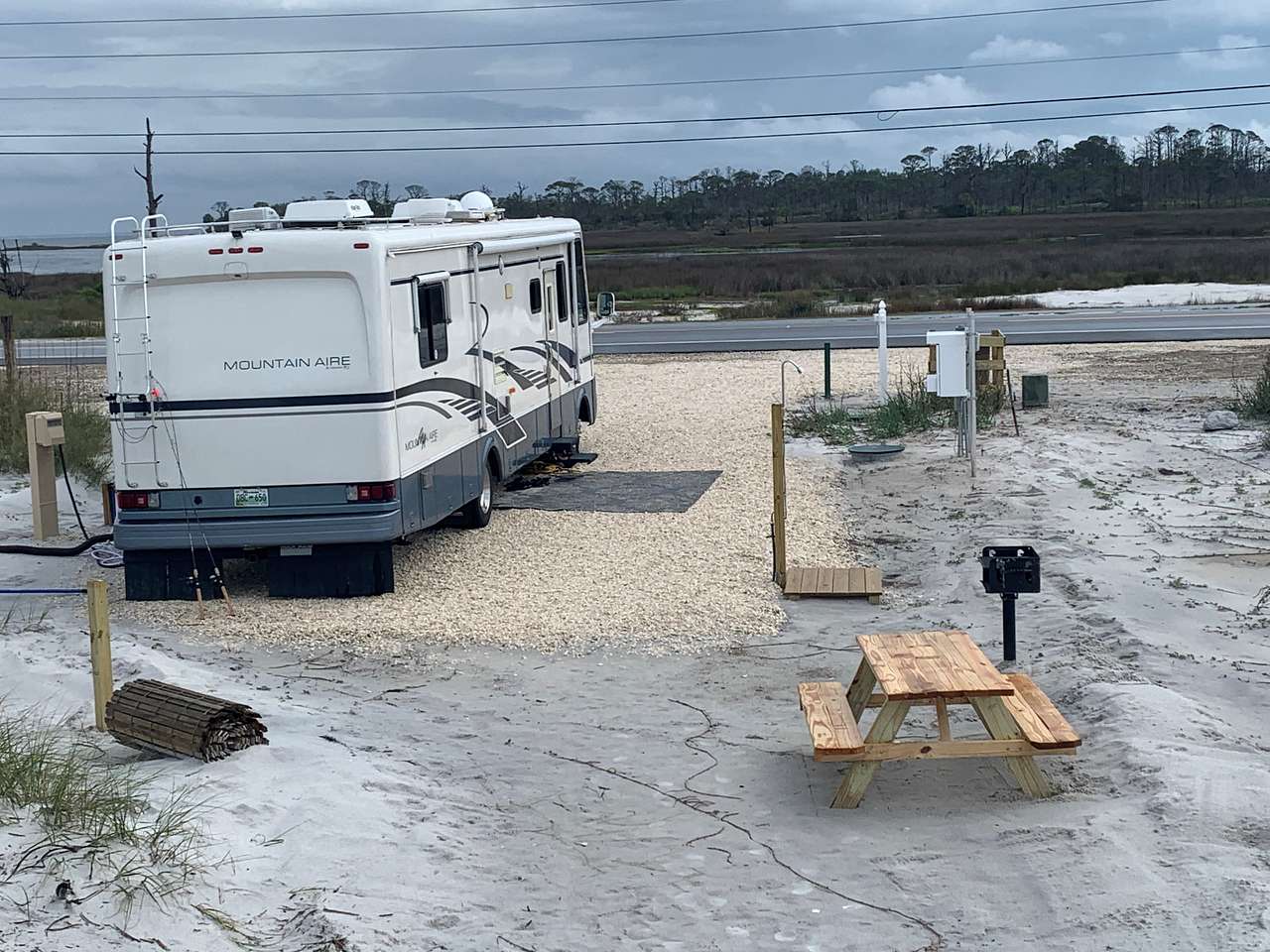 picnic table, grill, and outdoor shower