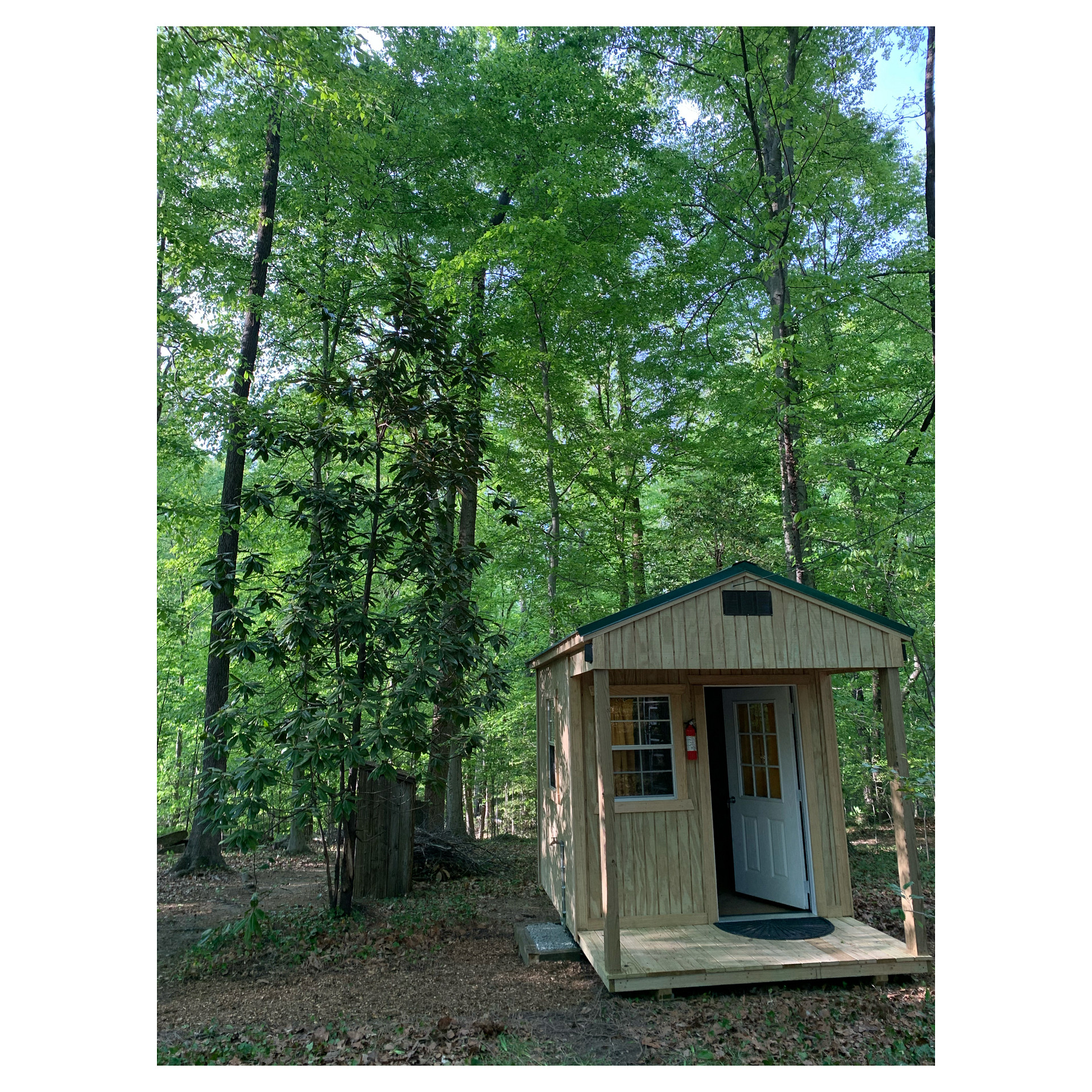 Shared restroom w/ composting toilet, hand washing sink, and privacy.