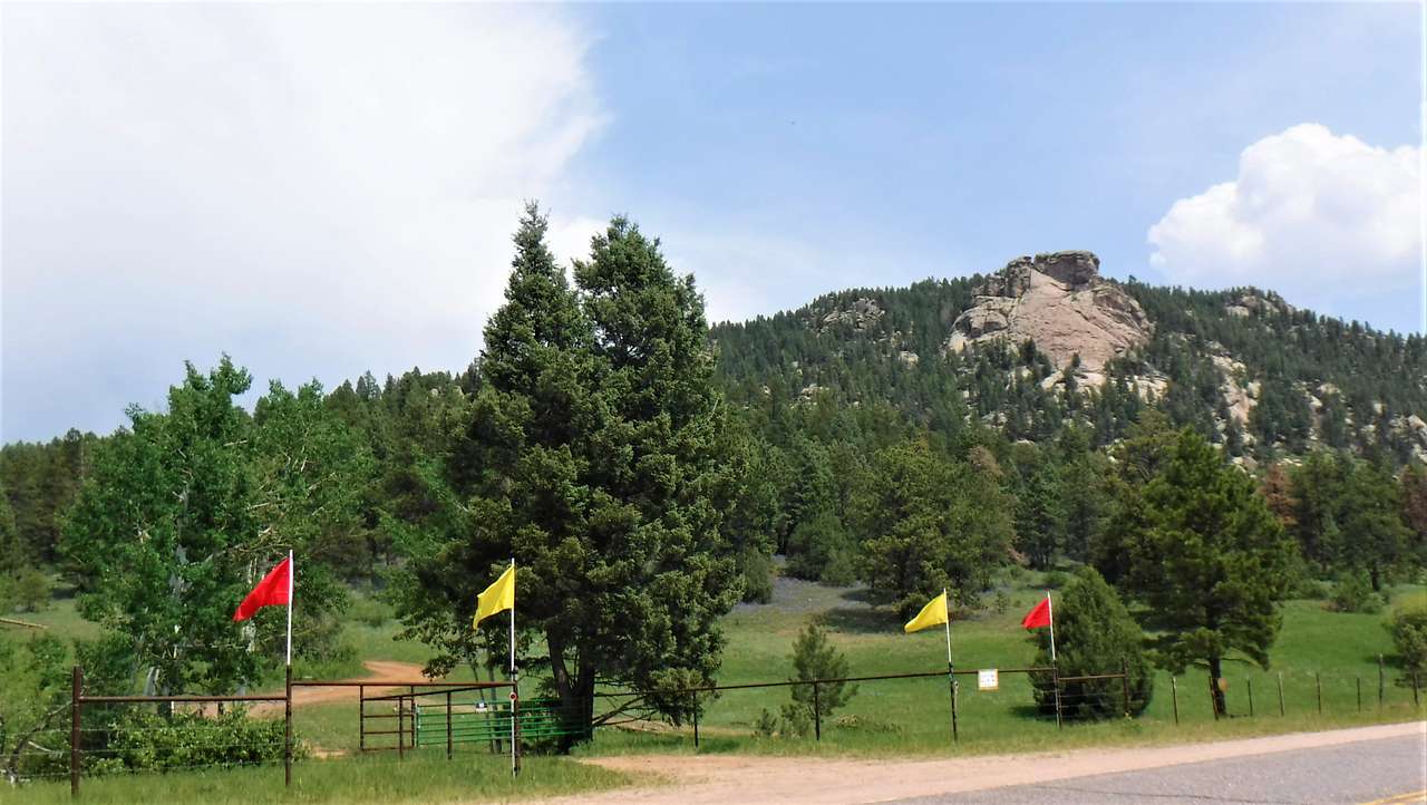 Little Scraggy Peak and the Camp's front gate, marked with red and yellow flags.