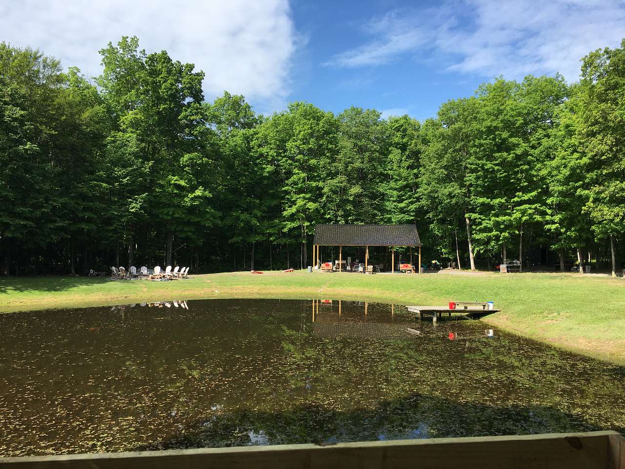 Front porch views of our Dining Pavilion and Fire pit across the pond. 