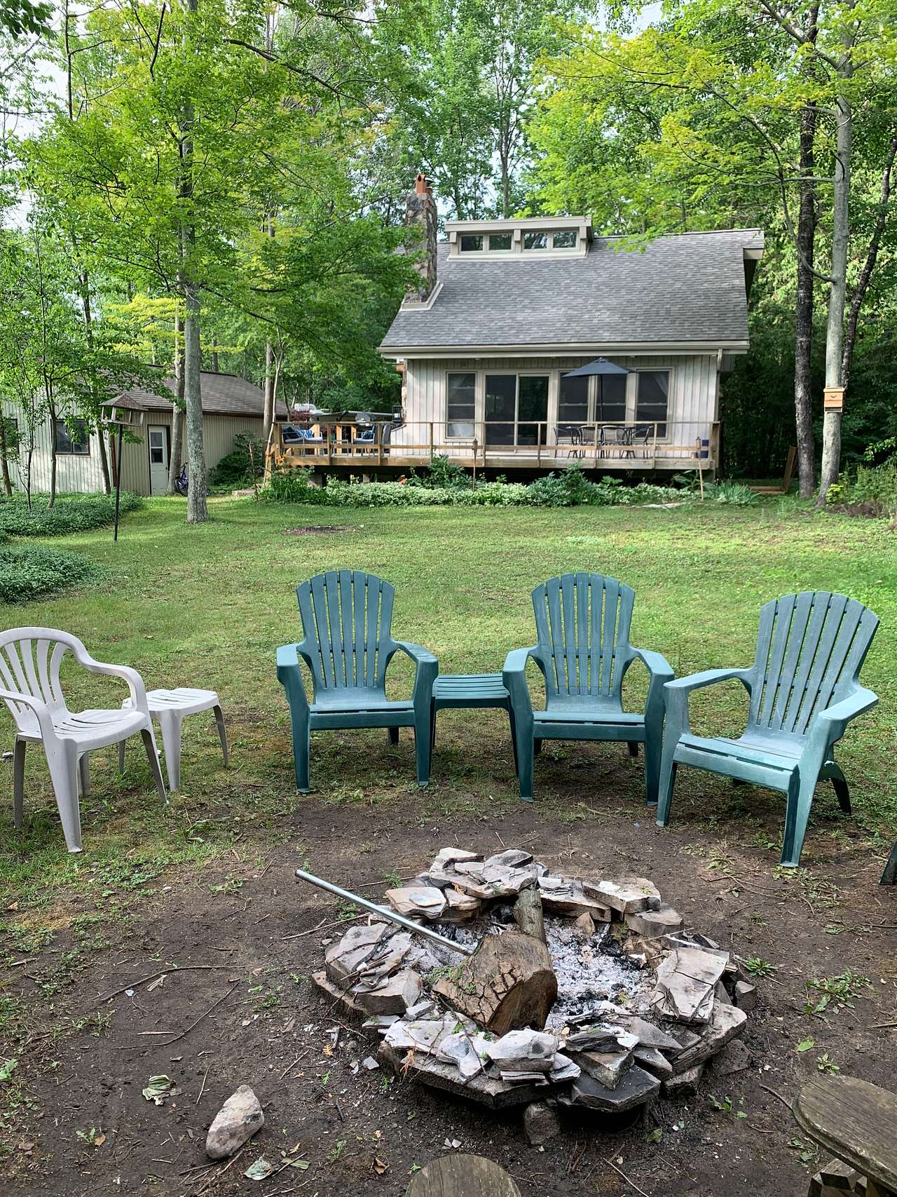 Fire pit at the back of the property for you to enjoy. Kindling, firewood, and marshmallow roasting sticks provided