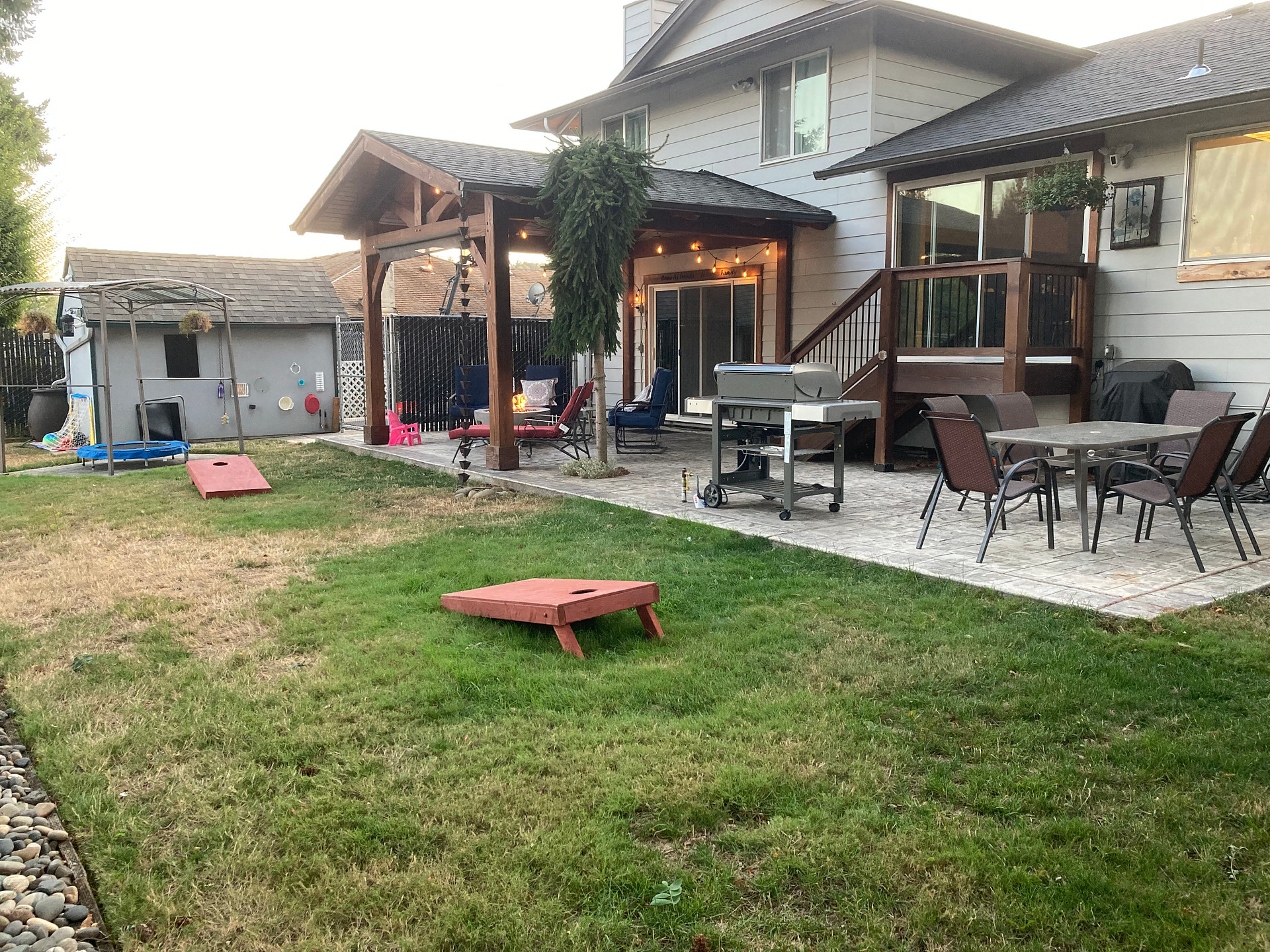 Shared backyard space includes patio table with 6 chairs, natural gas grill, natural gas fire pit with lounge chairs. 