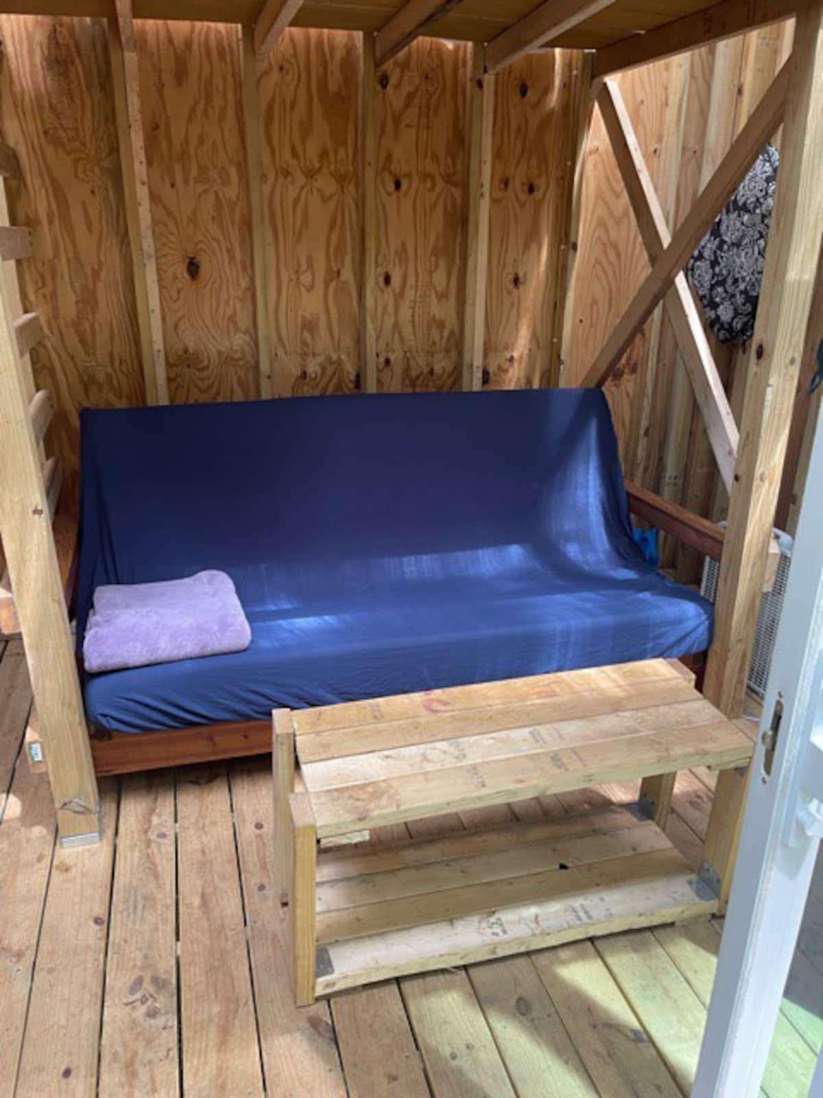 Wood-framed futon with a memory foam mattress.