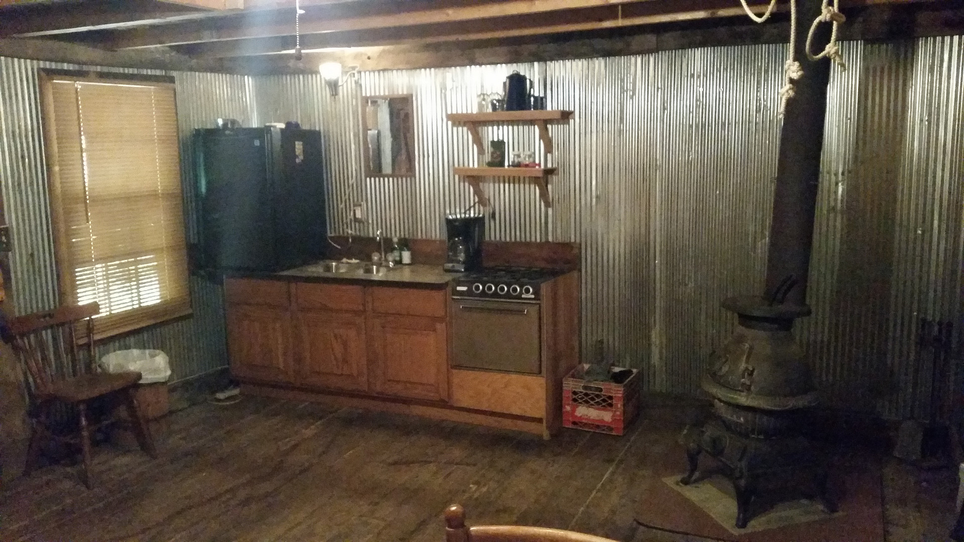 Kitchenette with mini fridge, running water and propane stove.