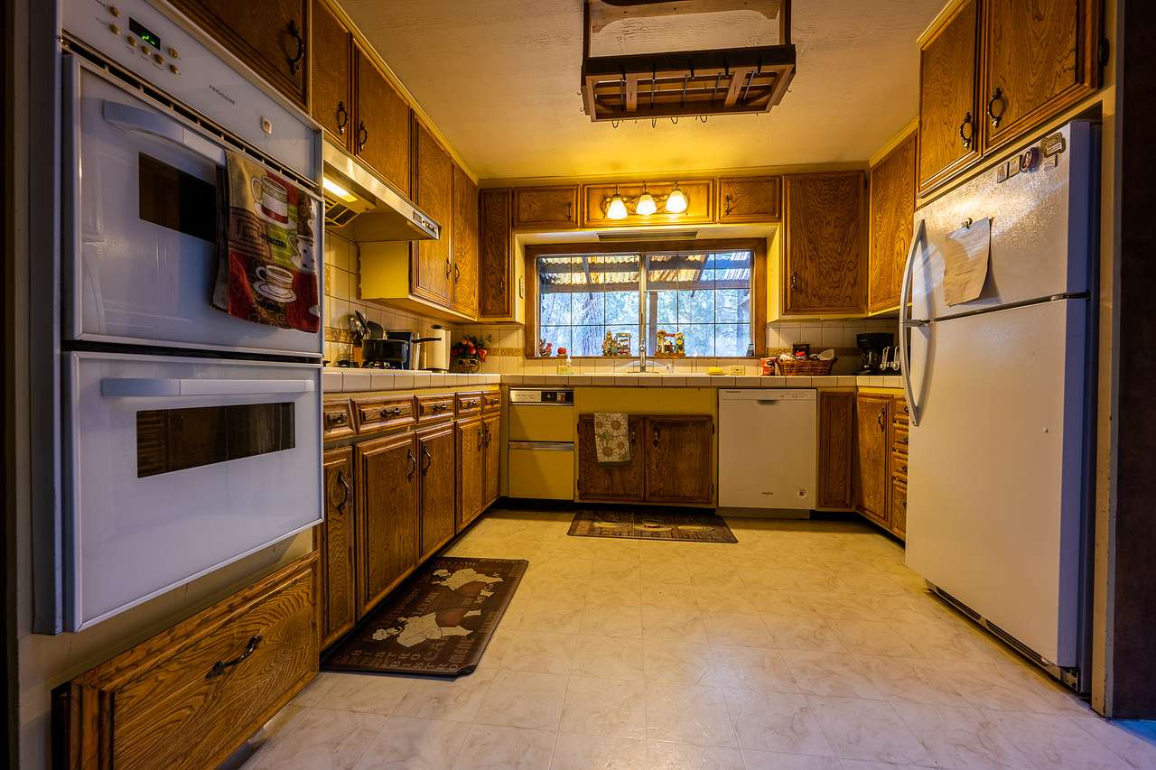 Large kitchen stocked with pots, pans, dishes, silverware, etc. 