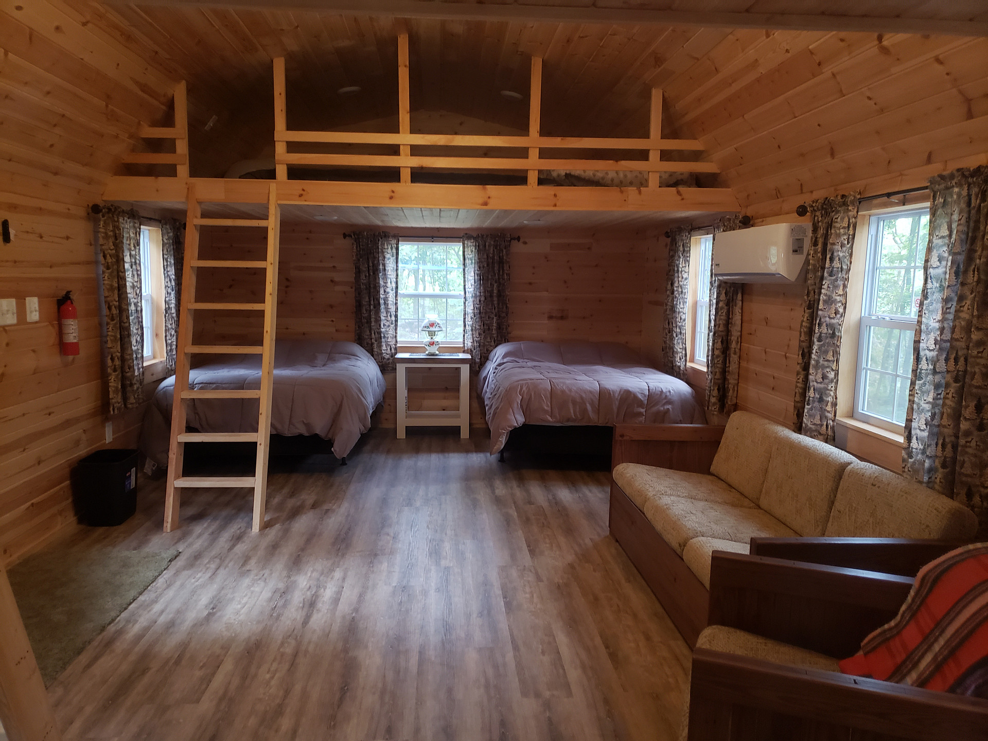 Tanner's Bunkhouse Glamping Clear Spring Maryland 3-Cabin Campground has 4 full beds, 2 lofts, a couch, a chair, dog bed, heat and AC.