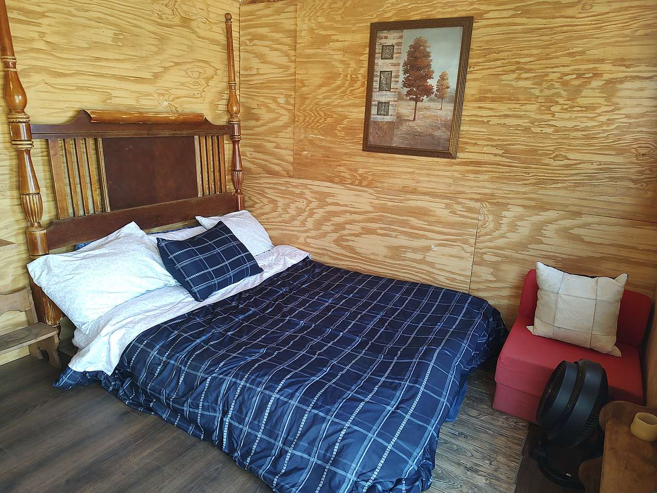 Queen size bed and the red chair folds out into a lounge/small bed.