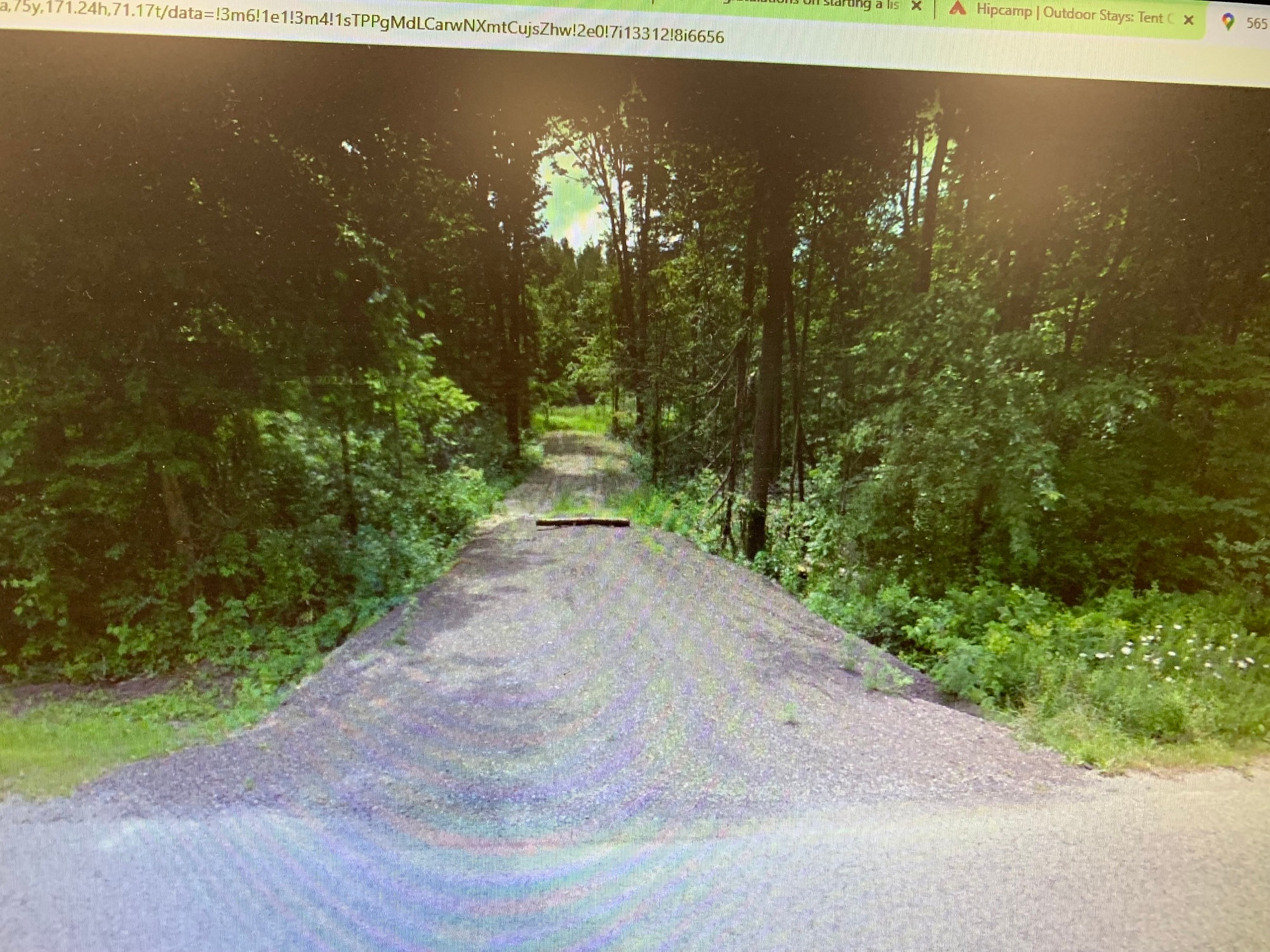 This is a view from the road.  The log across the private driveway is not there.