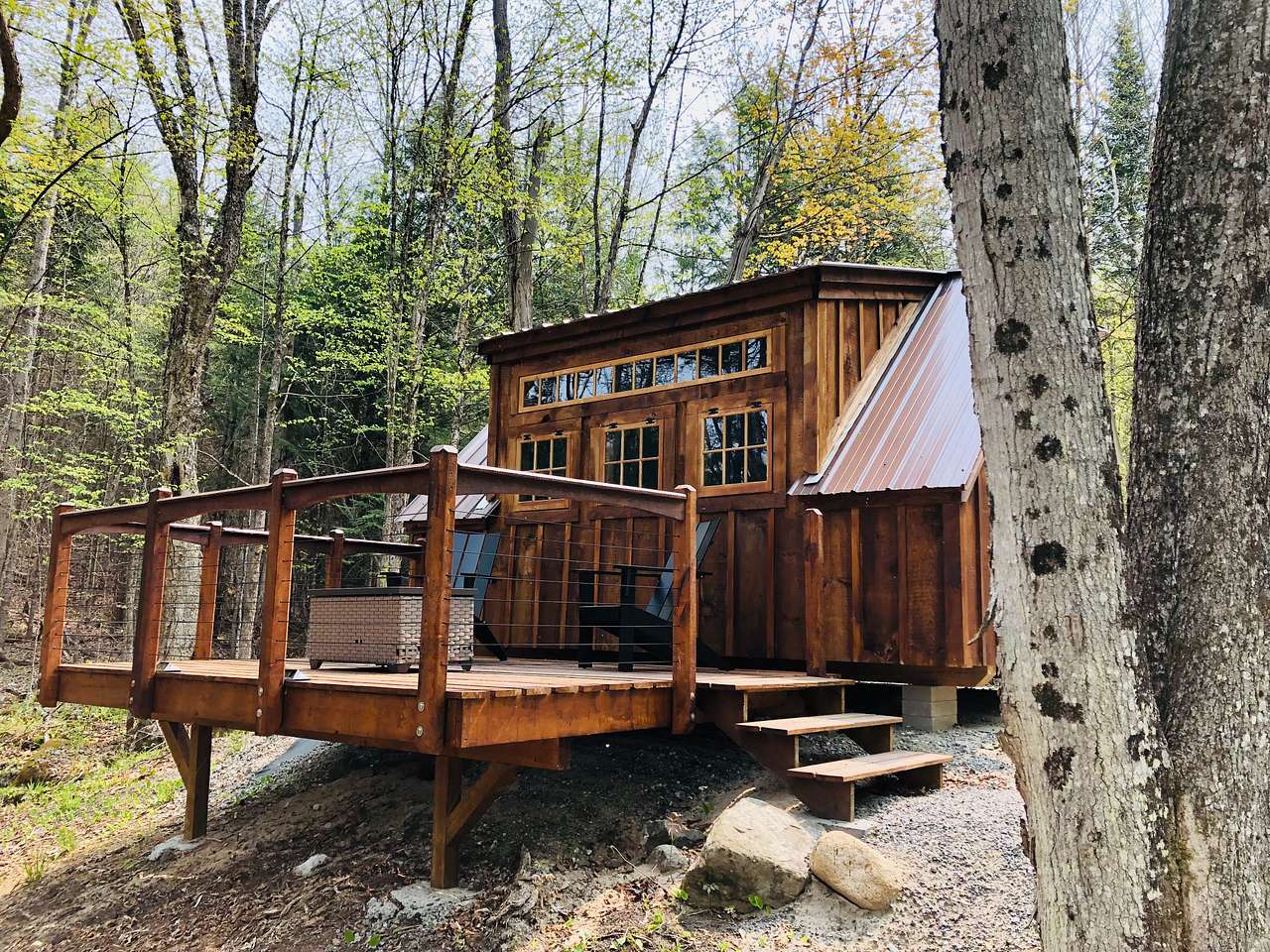 Outside looking up at tiny cabin from driveway
