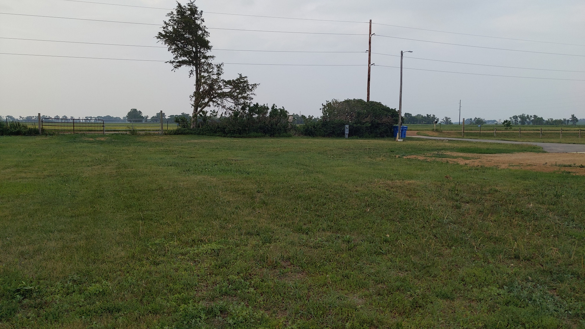 Looking north, gravel entrance & asphalt driveway entrance.