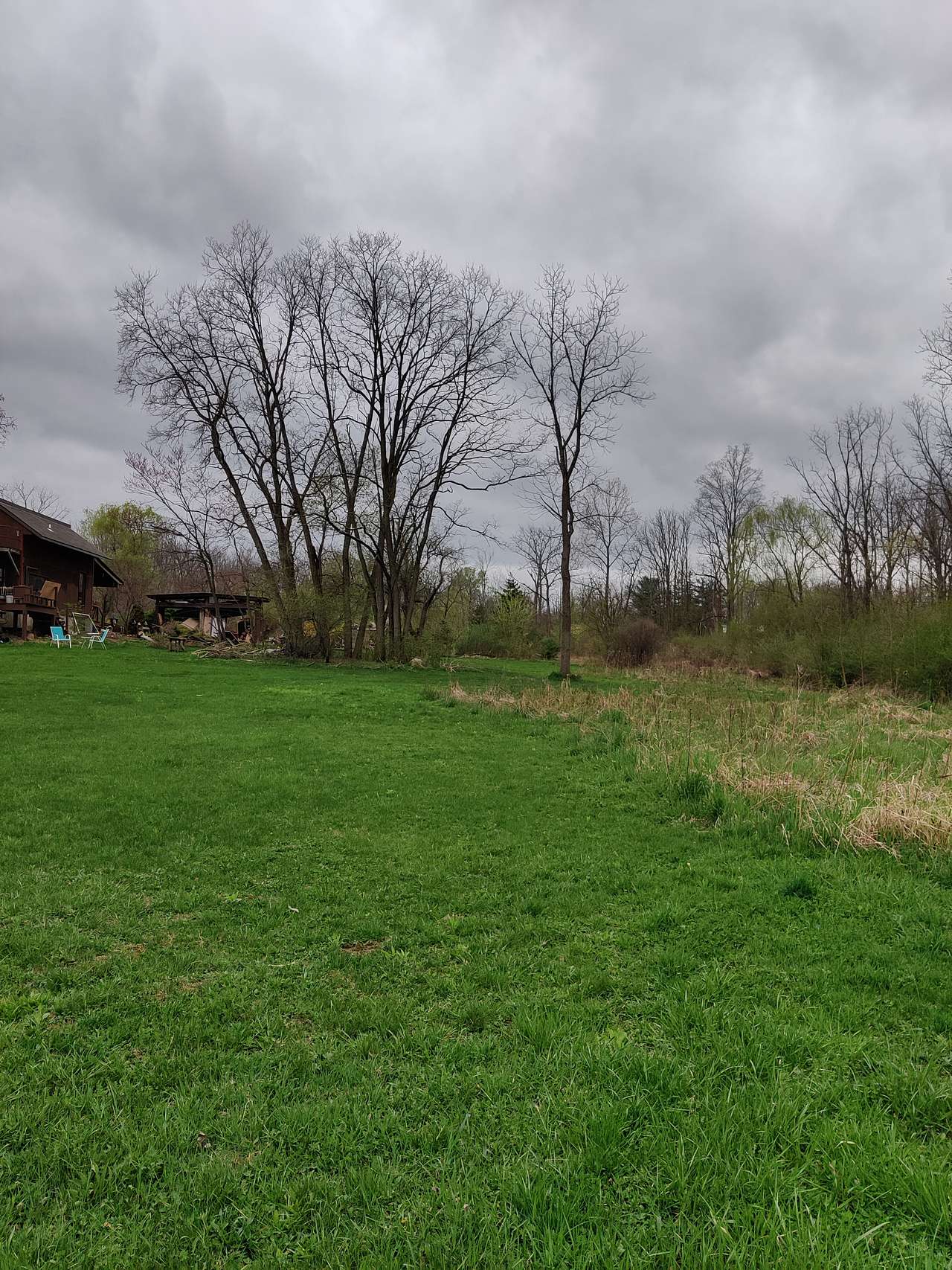 On the East lawn, with the house, woodshed and utility area.