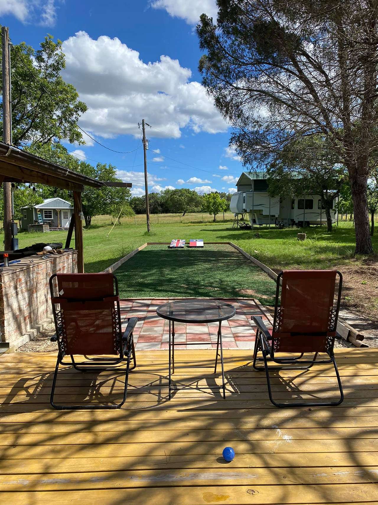 Deck and sport court facing covered RV spot (Summer)