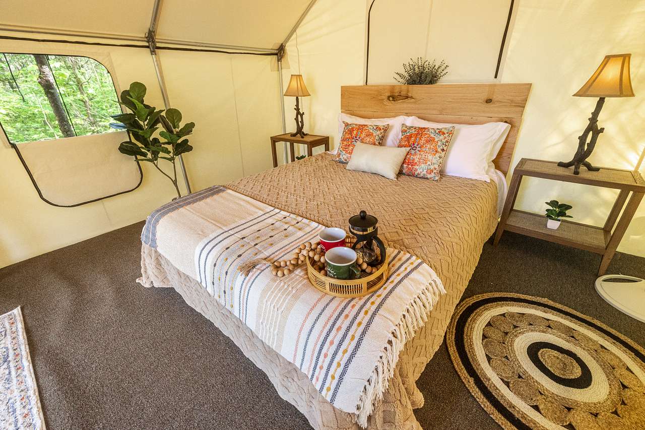 Plush queen size bed with comfortable linens for a restful nights sleep. Night stands with lamps and power to charge devices.