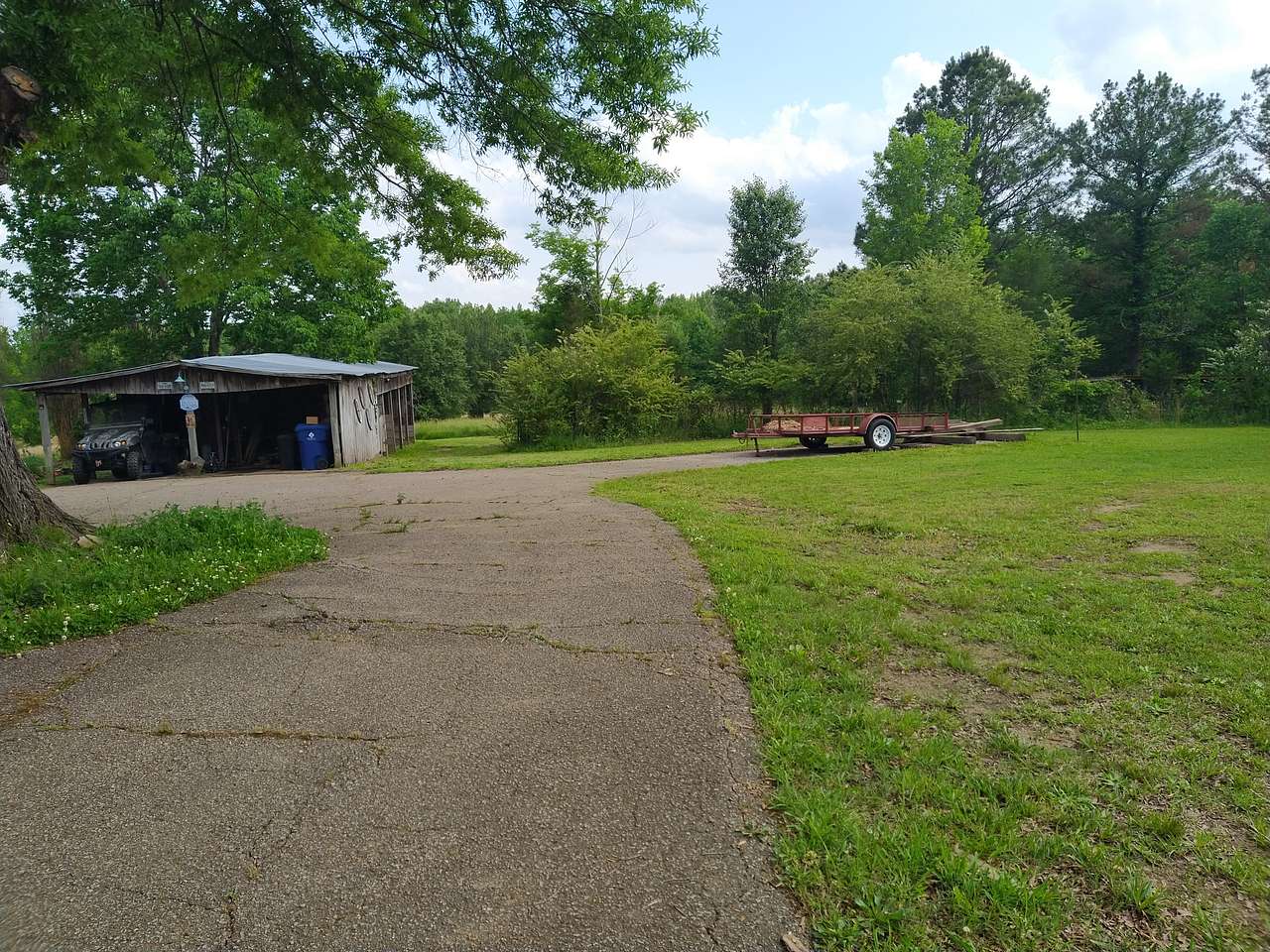 Driveway onto the property, pasture gate to the right of the barn 