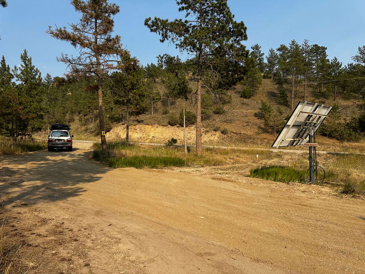 RV site next to solar panel, & pull through exit.