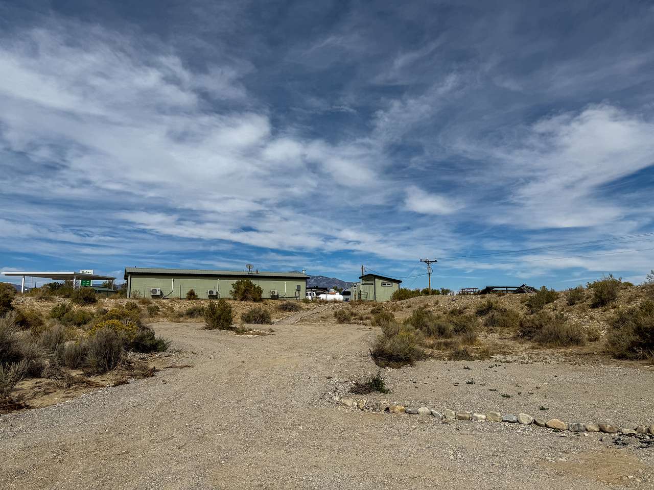 The small green building on the right is the restroom building. There is a picnic table along the top of the hill that is available for camper's use.