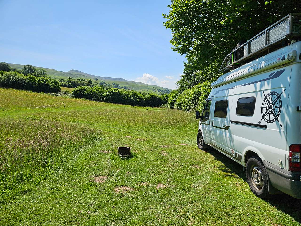 Van pitches are grass and accessed via a grass track that runs from carpark. Size varies but all will fit a small campervan (maximum size VW/Transit style vehicle - this is because of access into the meadows being through a field gate.) Views are of the surrounding mountains :) Roof tent campers will want to book a van pitch. 