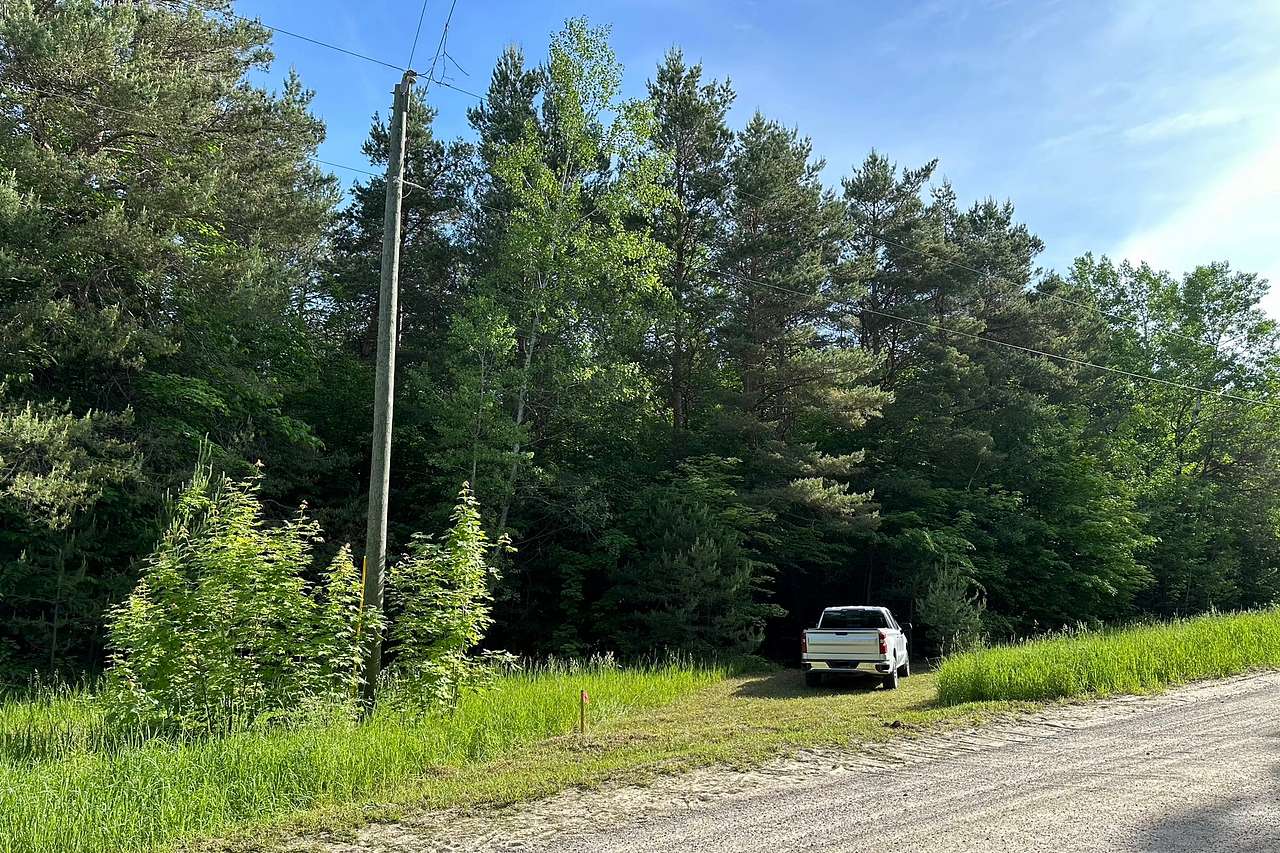 Photo from the road. I’ve since added a post with an address sign that is visible from the road. My property is off a dirt road. However the roads leading to it are paved. If you come from the east it is 0.7 miles of dirt road or 0.3 miles from the west. 