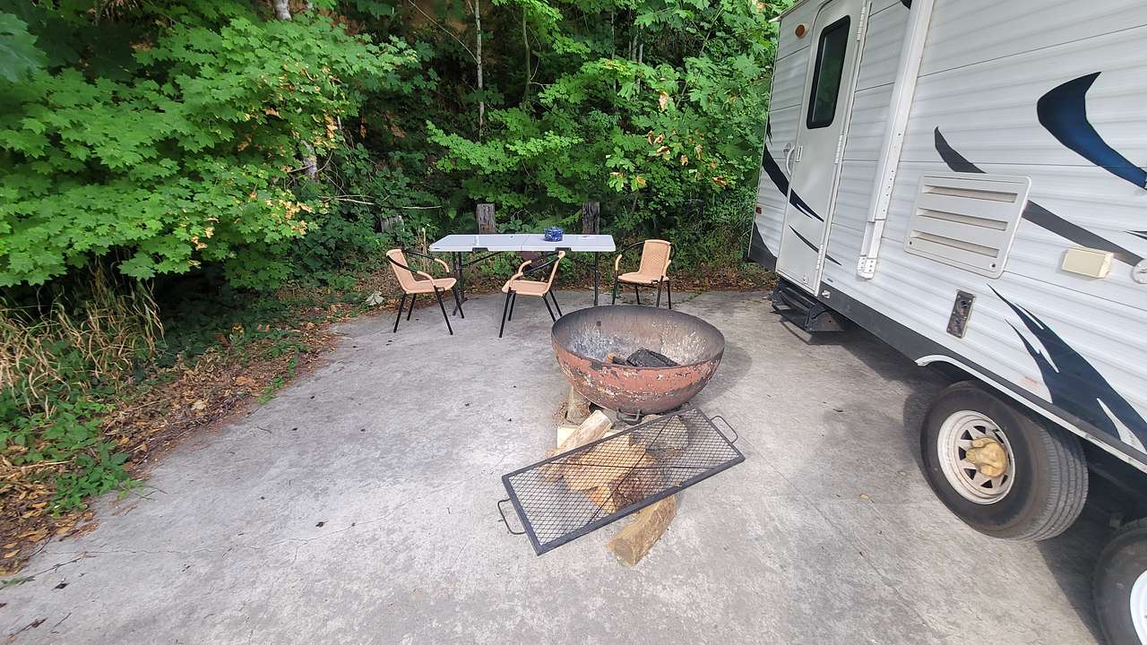 Table, chairs and fire pit, even some wood