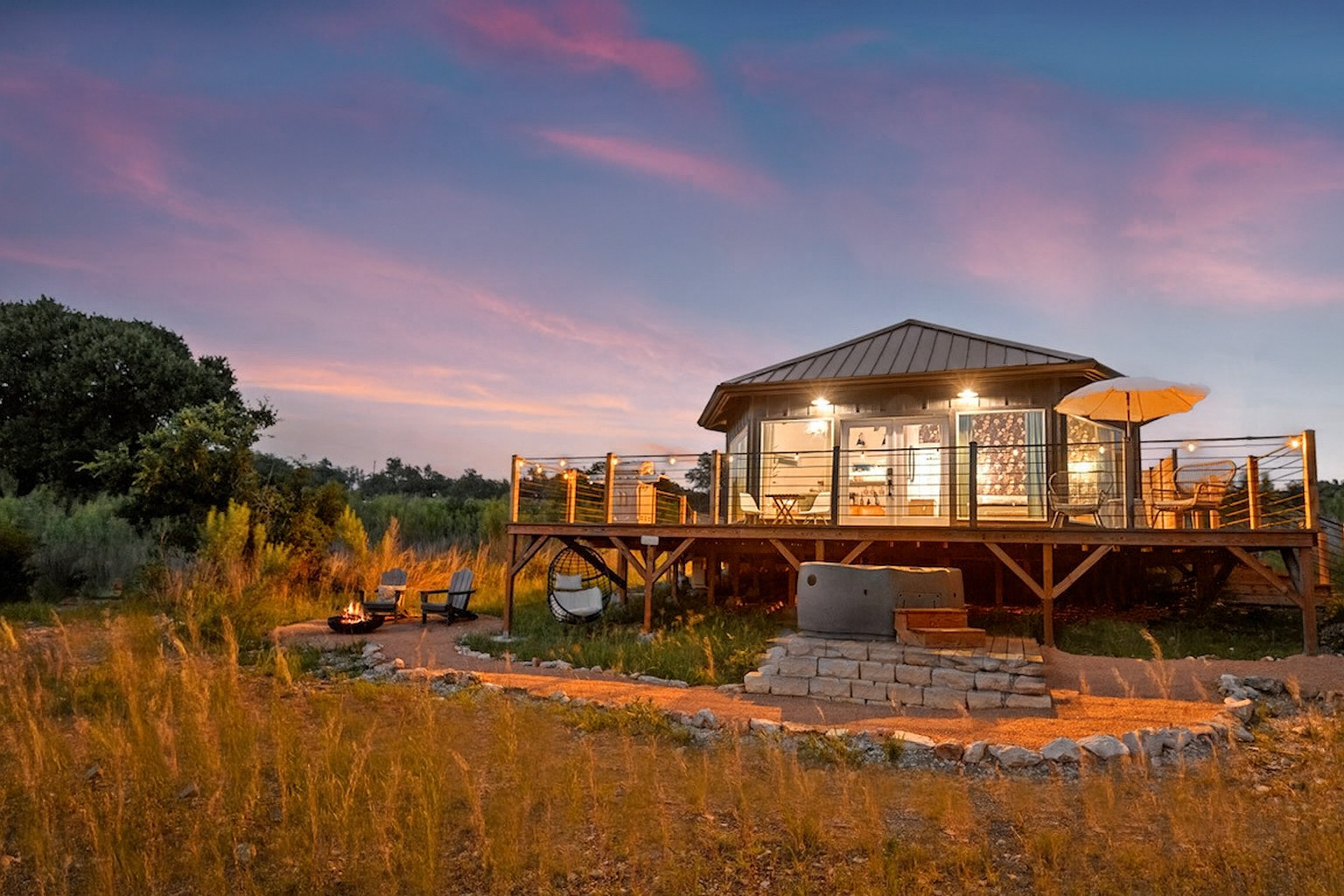 The Hex all-wood yurt is a cozy retreat surrounded by floor-to-ceiling windows. Natural light floods the space and showcases nature and wildlife.