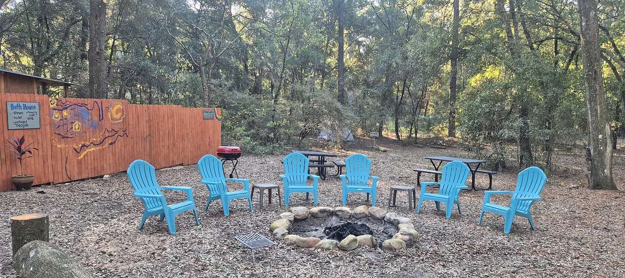 Central fire, picnic tables, grill, art wall