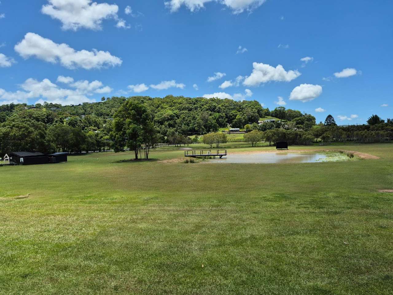 View from main house to the dam. Site 5 is located behind the tree just to the left of the dam and Site 6 is located across the dam to the right of the black bus stop where eggs and firewood are available for purchase. 