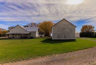 The back of our heritage-style wooden barn. Barn swallows love this spot — keep an eye out!