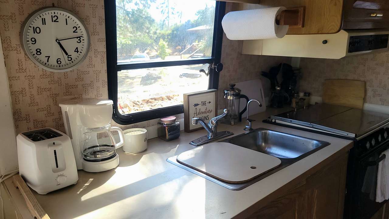 Kitchen area in RV for your use while at Sun Set Camp. Kitchen utensils and coffee, tea, etc inside cabinets. 