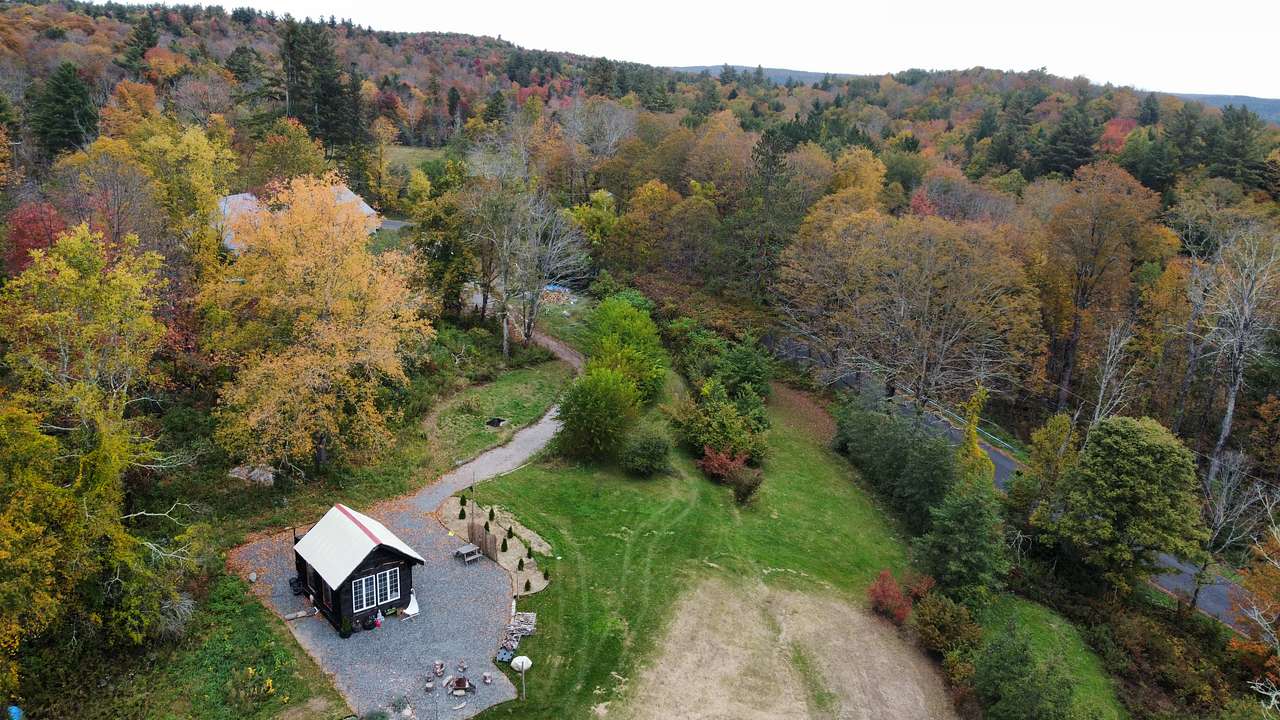 aerial view of the cabin and the proximity to the road. my husband and I live on-site and guests might sometimes see us doing work on the property. 