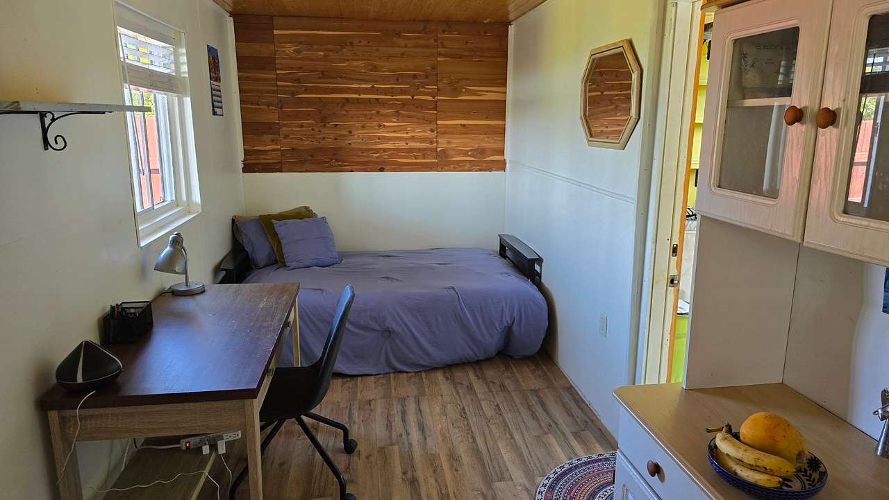 Inside container 1 bed, desk and kitchen table. 