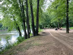 View down the riverbank overlooking campsites
Standing at Hammock hanger