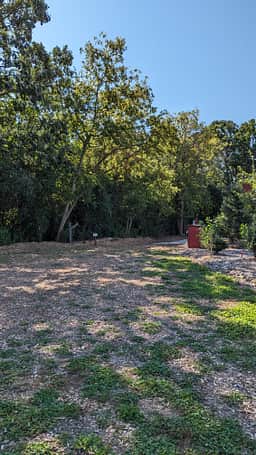 Campsite and RV site nextdoor. Wooded area behind.